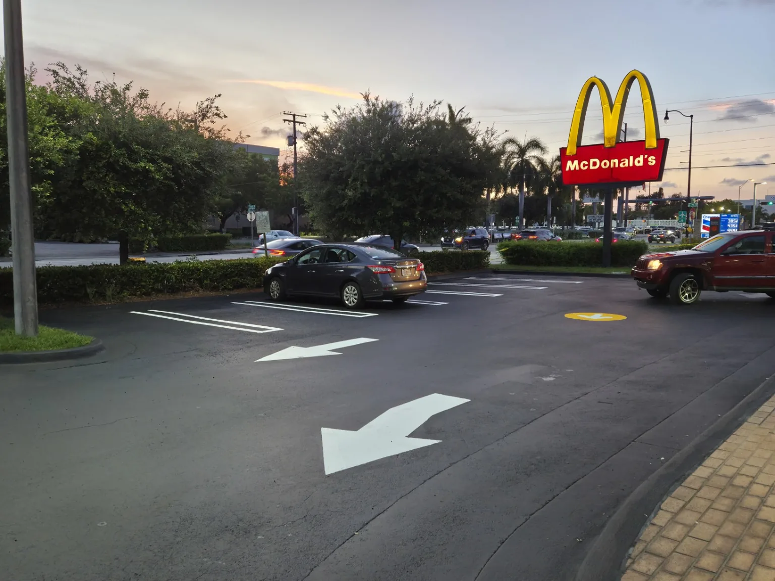 Completed commercial parking lot at dusk with fresh markings