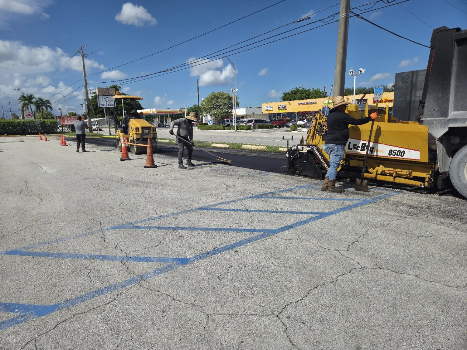 Asphalt paver and crew installing new asphalt