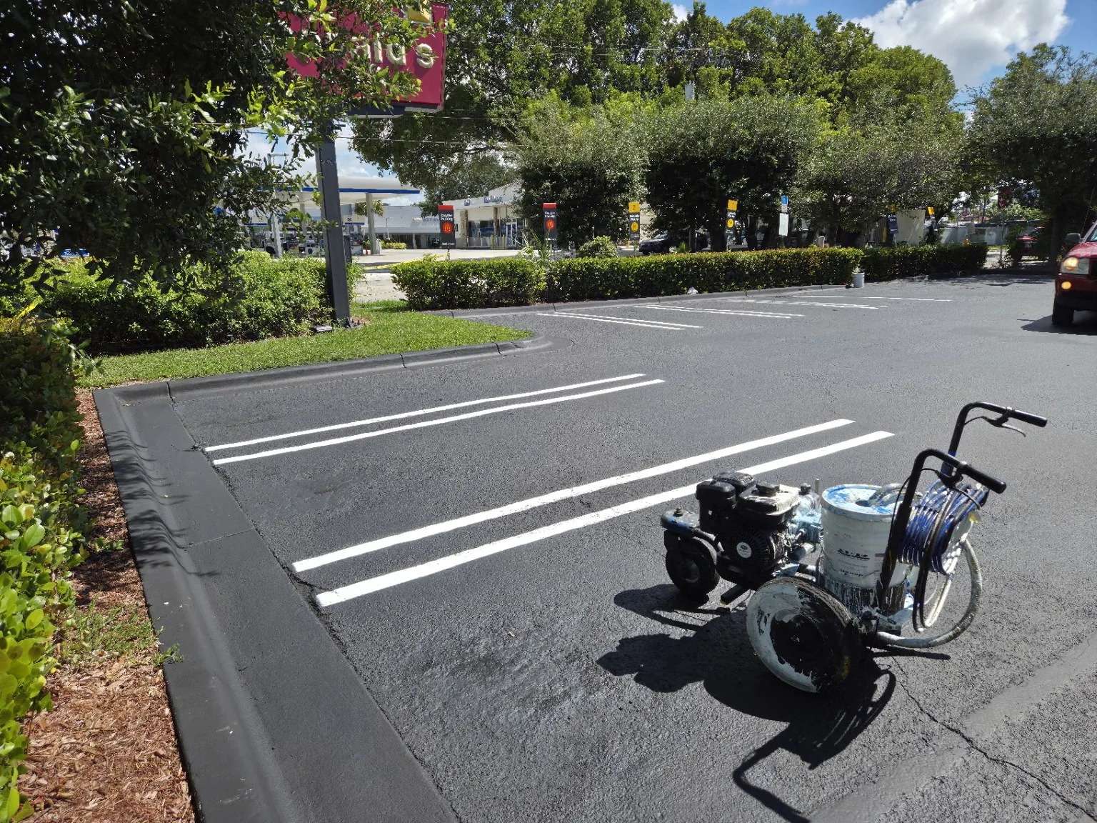 Fresh white parking lot striping on sealed asphalt